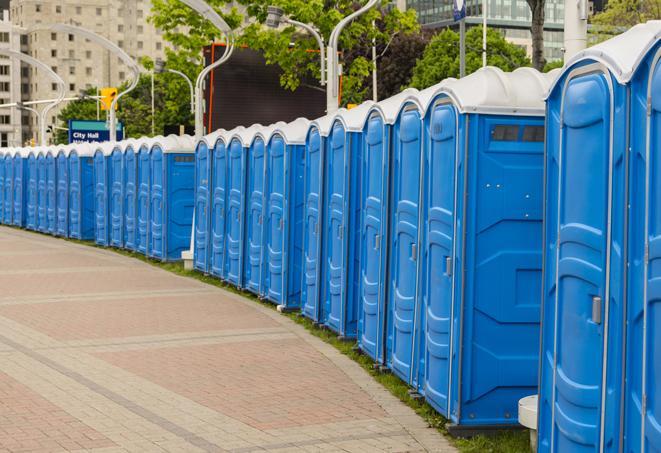 a row of portable restrooms set up for a large athletic event, allowing participants and spectators to easily take care of their needs in Azusa